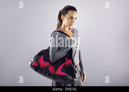 Premium Photo  Fit young woman with gym bag and yoga mat opening door of  yoga studio