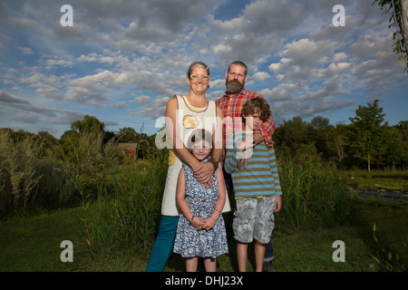 Portrait of couple with children on family herb farm Stock Photo