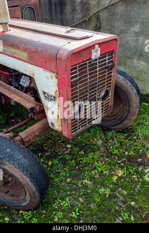 Old, rusty International Harvester tractor waiting to be restored. Stock Photo