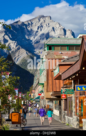 People strolling down Banff Avenue Banff town and Cascade Mountain Banff national Park Alberta canada North America Stock Photo