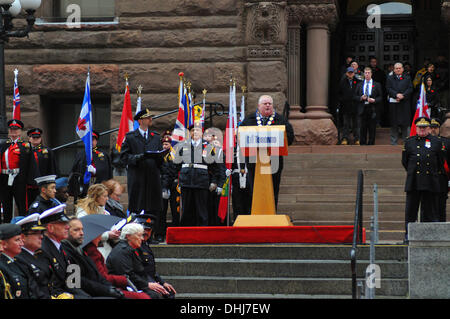 Toronto, Canada. 11th Nov, 2013. surrounded by dignitaries, amidst Torontonians of all stripes, Mayor Rob Ford delivers a commemorative speech on the steps of Toronto's Old City Hall, during Remembrance Day Ceremonies at Toronto, Ontario, Canada. Credit:  Gregory Holmgren/Alamy Live News Stock Photo