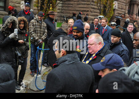 Toronto, Canada. 11th Nov, 2013. having just attended Remembrance Day Ceremonies and delivered a commemorative address at The Cenotaph of Old City Hall, at Toronto, Ontario, Canada, Mayor Rob Ford is beset by throngs of reporters. Credit:  Gregory Holmgren/Alamy Live News Stock Photo