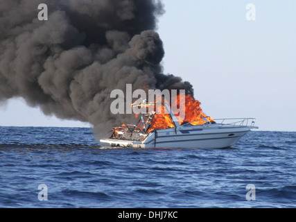 Fire on a speedboat in the water Stock Photo