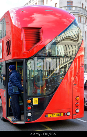Conductor on hop on hop off platform of new Boris double decker routemaster bus Stock Photo