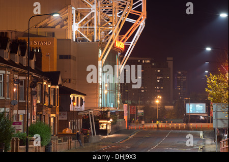 An almost empty night time Sir Matt Busby Way approaching Old Trafford stadium, home of Manchester United (Editorial use only). Stock Photo