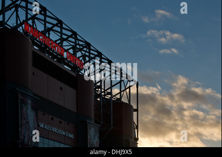 A near silhouette of the Alex Ferguson stand of Old Trafford, home of Manchester United, sunset background (Editorial use only).