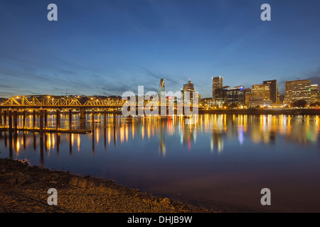 Portland Oregon Downtown Skyline with Hawthorne Bridge Along the Banks of Willamette River at Evening Blue Hour Stock Photo