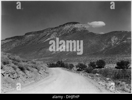 This image shows a lava-capped mesa located to the north of the road and northeast of Virgin, Utah. Lava-capped mesas are geological formations formed from ancient volcanic activity, offering dramatic landscapes. Stock Photo