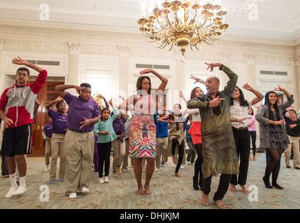 First Lady Michelle Obama joins students for a Bollywood Dance Clinic in the State Dining Room of the White House, Nov. 5, 2013. Stock Photo