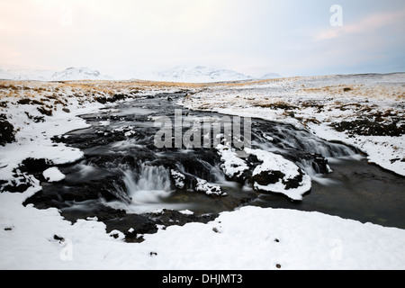 View on a stream with waterfall in Icelandic landscape. Stock Photo