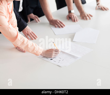 Close up of arms and hands of business people in the office having a business meeting Stock Photo