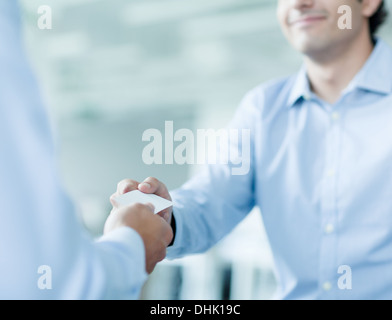 Close up of two businessmen exchanging business cards Stock Photo