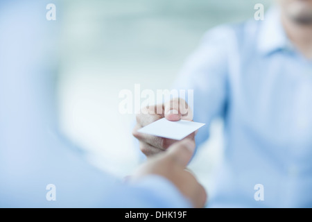 Close up of two businessmen exchanging business cards Stock Photo
