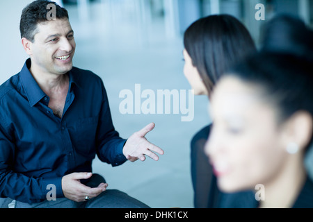 Business colleagues talking amongst themselves in the office Stock Photo