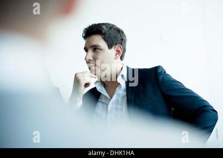 Young businessman listening in a business meeting Stock Photo