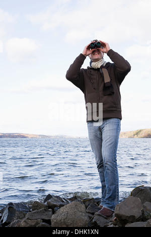 A man using binoculars Stock Photo