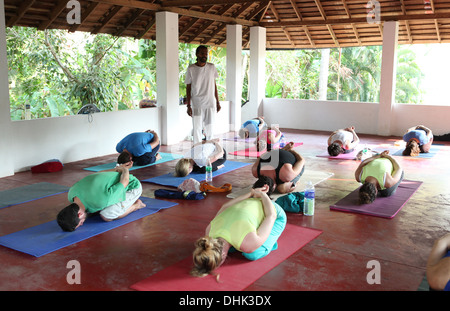 Yoga teacher and class during an exercise Stock Photo