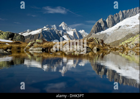 Reflection on lake Bettmersee, Bettmeralp, in the background Bernese Oberland, Canton of Valais, Switzerland, Europe Stock Photo