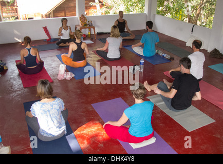 Yoga teacher and class during an exercise Stock Photo