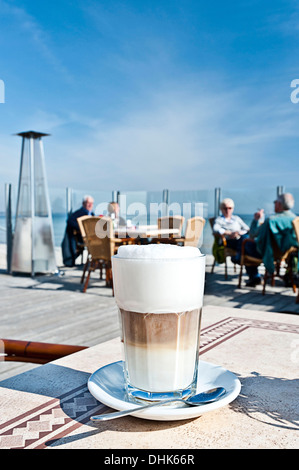 Latte macchiato in a cafe with seaview, Scharbeutz, Schleswig Holstein, Germany Stock Photo