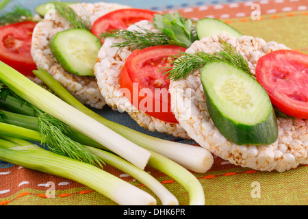 Puffed rice crackers sandwiches with vegetables on tablecloth. Stock Photo