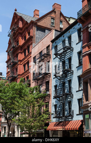 Cast-iron architecture buildings in Soho in New York City, with trees ...
