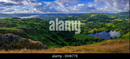 A panoramic view from Loughrigg towards Windermere in the distance, in the morning with shadows on the landscape. Stock Photo