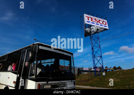 bus with passengers passes by advertising on supermarket tesco, As Czech Republic Stock Photo