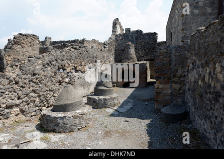 View of broken mills and an oven in the bakery at the House of Pansa, Pompeii Italy. Stock Photo