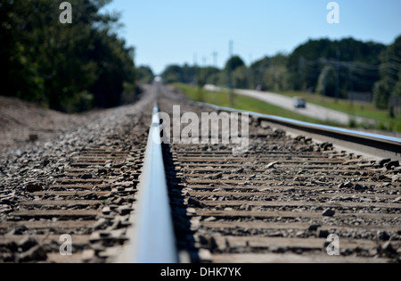 Long straight American train rail track disappears into the distance Stock Photo