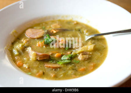 Traditional Dutch green peasoup with sausage Stock Photo