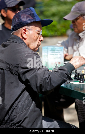 Group Of Senior Men Playing In Saturdays Chess Match In Bryant Park, New York City. Stock Photo