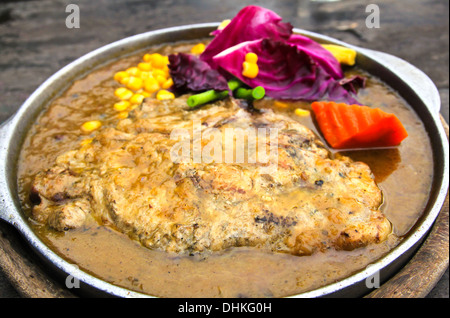 Roasted pork steak in a frying pan Stock Photo