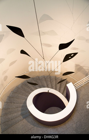 Black Spray, a hanging mobile with painted sheet metal by Alexander Calder, 1956, on display in a spiral staircase at Museo Cole Stock Photo