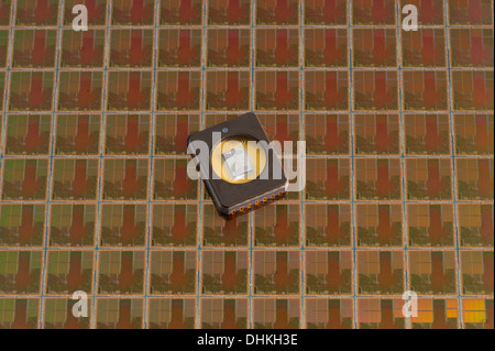 Memory chip, EPROM, on a silicon computer wafer.  The silicon die (memory chip) is visible under a glass window. Stock Photo