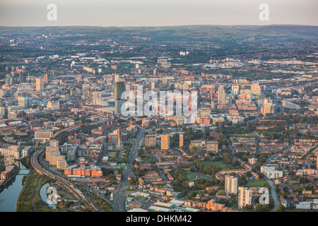 Helicopter Aerial view over Manchester at Dusk with the Peak District in the distant horizon Stock Photo