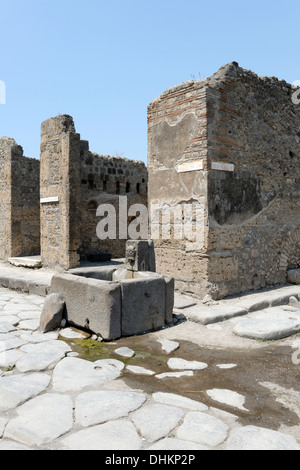 Fountain with a relief of a head of a bull along street Via della Fortuna, Pompeii Italy. Stock Photo