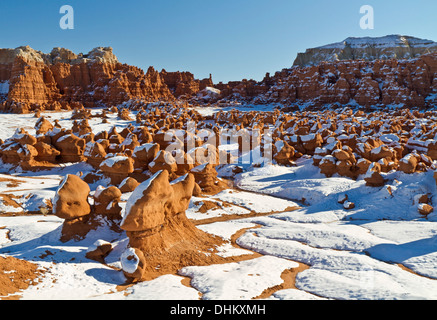 A valley filled with snow-covered hoodoos in Goblin Valley State Park, Utah Stock Photo