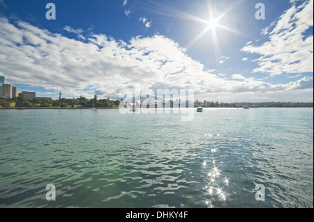 View of the Sydney Harbor from the sea against sun Stock Photo