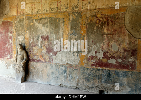 View of a statue of a youth with a cloak covering his head at the Portico north wall of the Stabian Baths, Pompeii Italy. The st Stock Photo