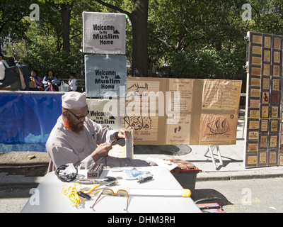 Annual Muslim Day Parade, New York City, 2013. Artisan creates Islamic-themed wares with wood-burning at Muslim street fair. Stock Photo