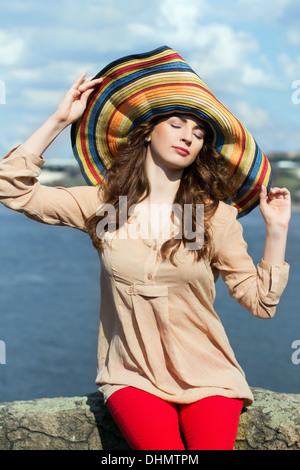 Young brunette in colorful hat Stock Photo