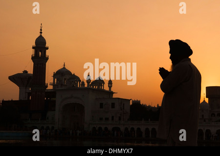 Silhouette of praying sikh man at golden temple of Amritsar, India Stock Photo