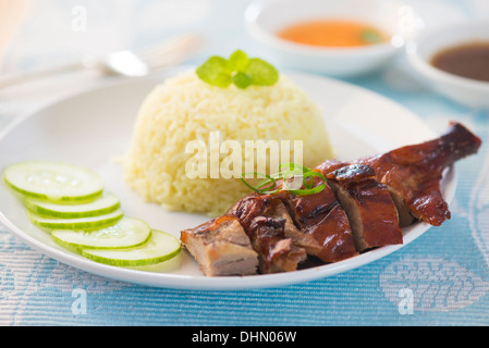 Roasted duck, Chinese style, served with steamed rice on dining table. Singapore cuisine. Stock Photo