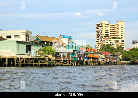 Residential buildings seen from boat along the Chao Phraya River in Bangkok , Thailand. Stock Photo