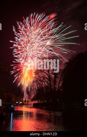 Cambridge firework display 2013 at Midsummer common, fireworks reflected in the River Cam. Stock Photo