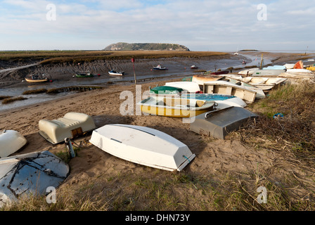 Small boats along the shore of the River Axe at Uphill at low tide. Stock Photo