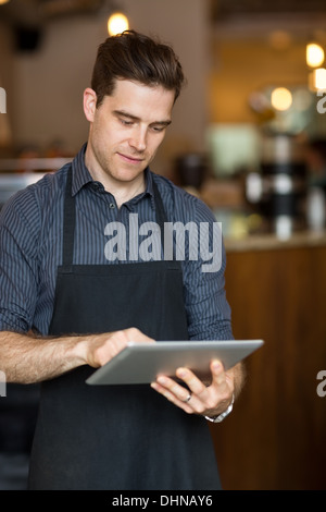 Male Owner Using Digital Tablet Stock Photo