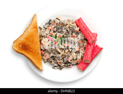 Seaweed salad with crab sticks on white plate Stock Photo