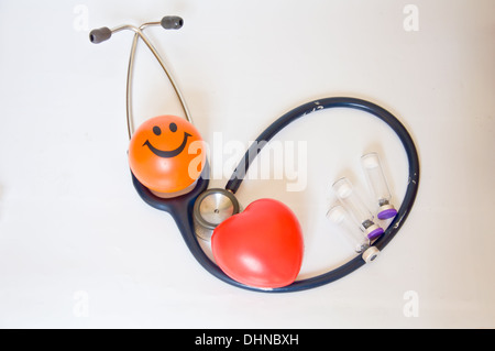 stethoscope and red heart with smile ball on white background Stock Photo